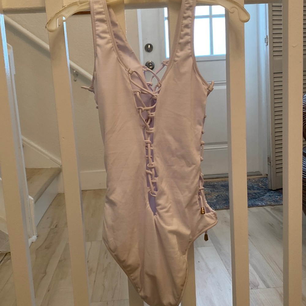 White one piece bathing suit criss cross ties front, back and sides